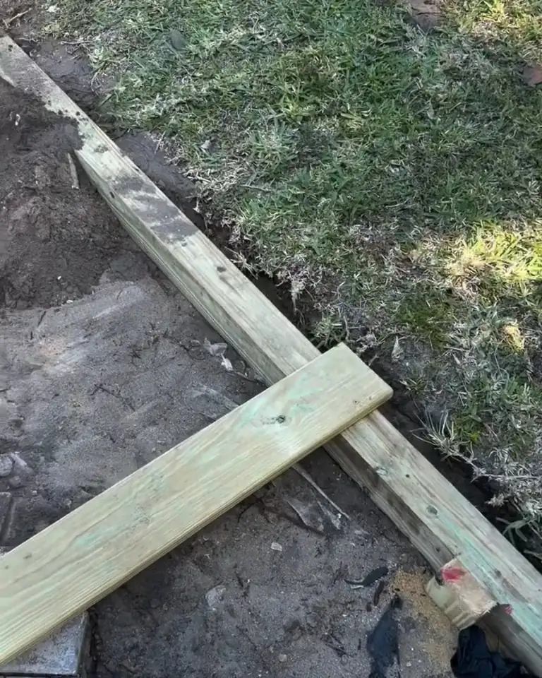 Bare, raked ground where a concrete patio used to be