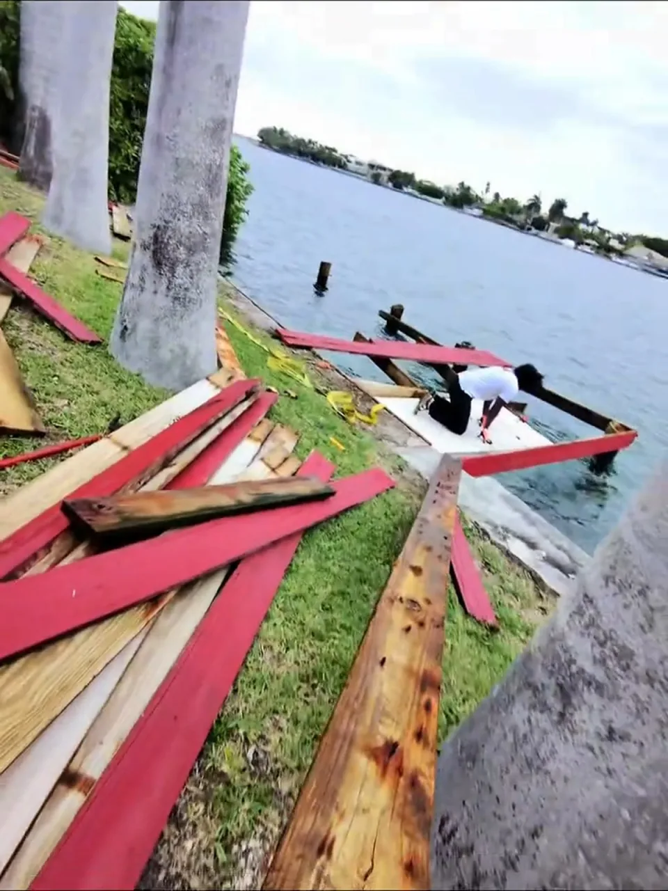Torn-out red dock boards on the lawn