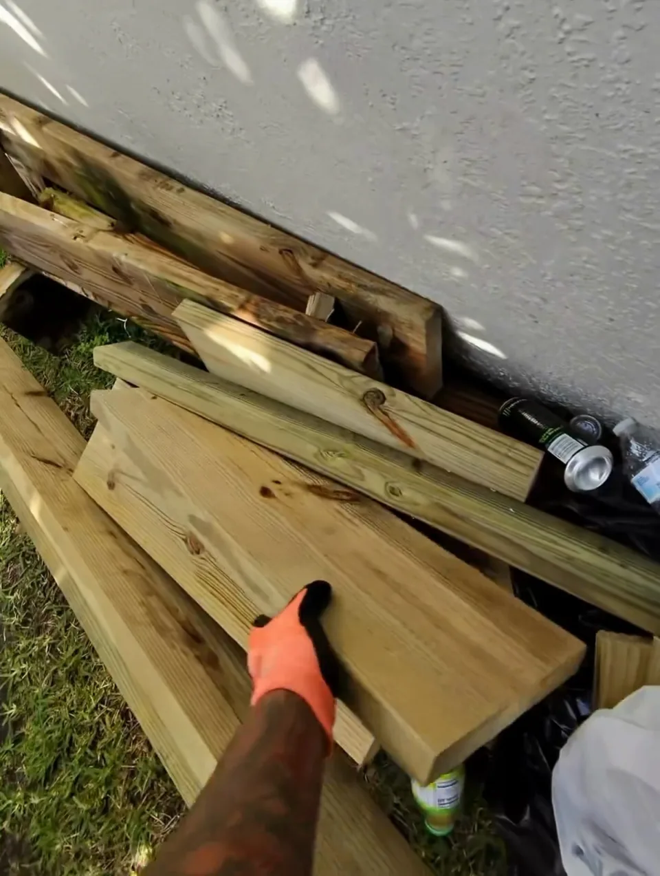 Crew loading drywall and lumber debris by hand