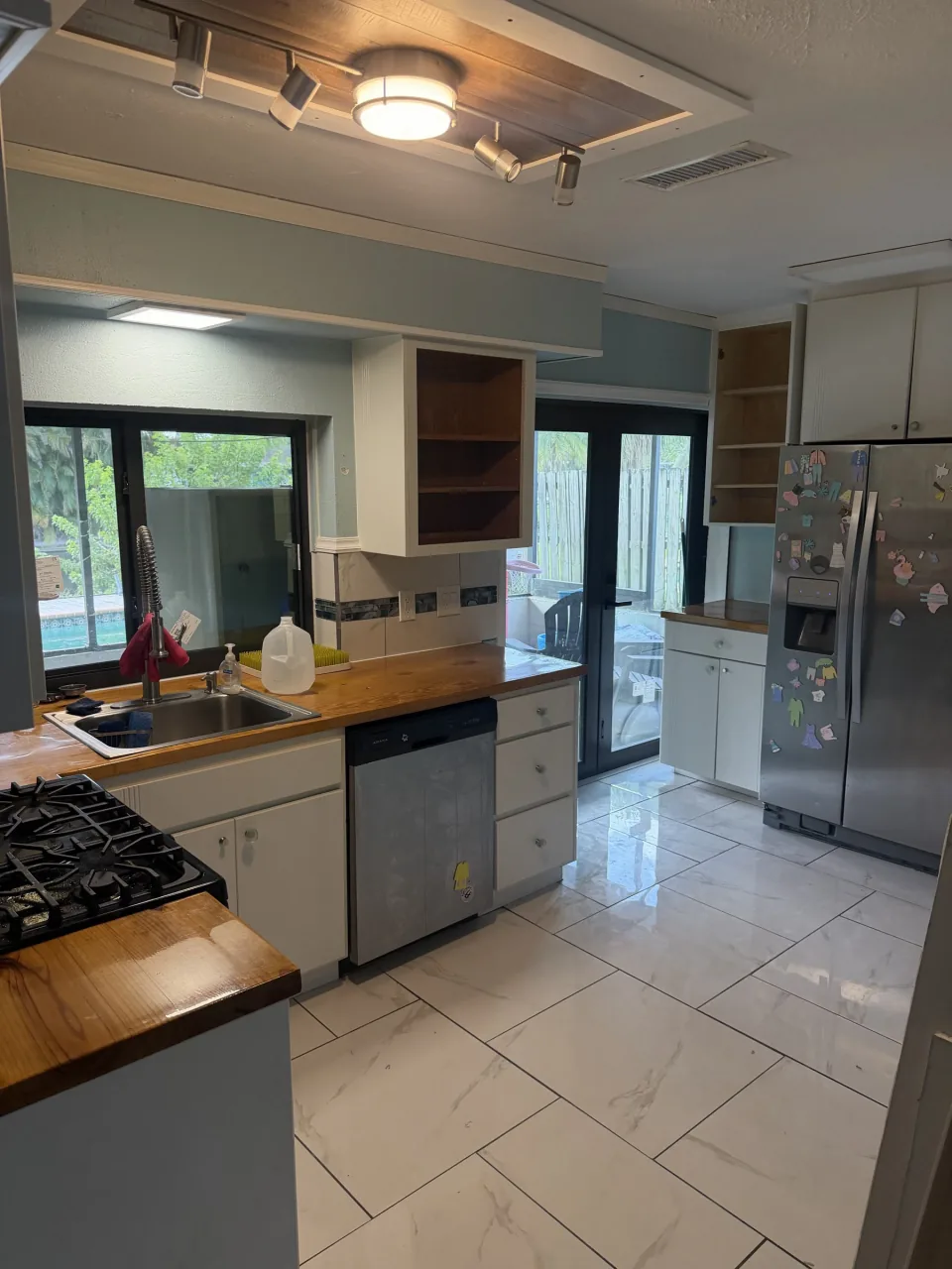 Kitchen with cabinets and counters before the tear-out