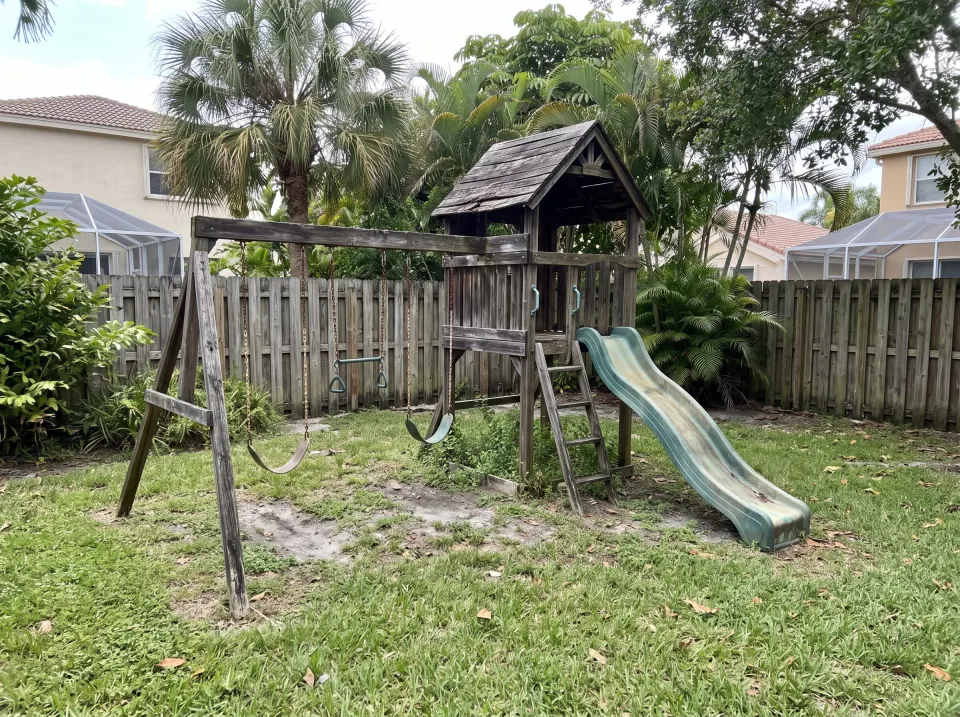 Illustration: an old white refrigerator, a rusted washer and a dryer pushed together in a Florida garage beside the water heater, with a cardboard box of old parts on the floor.