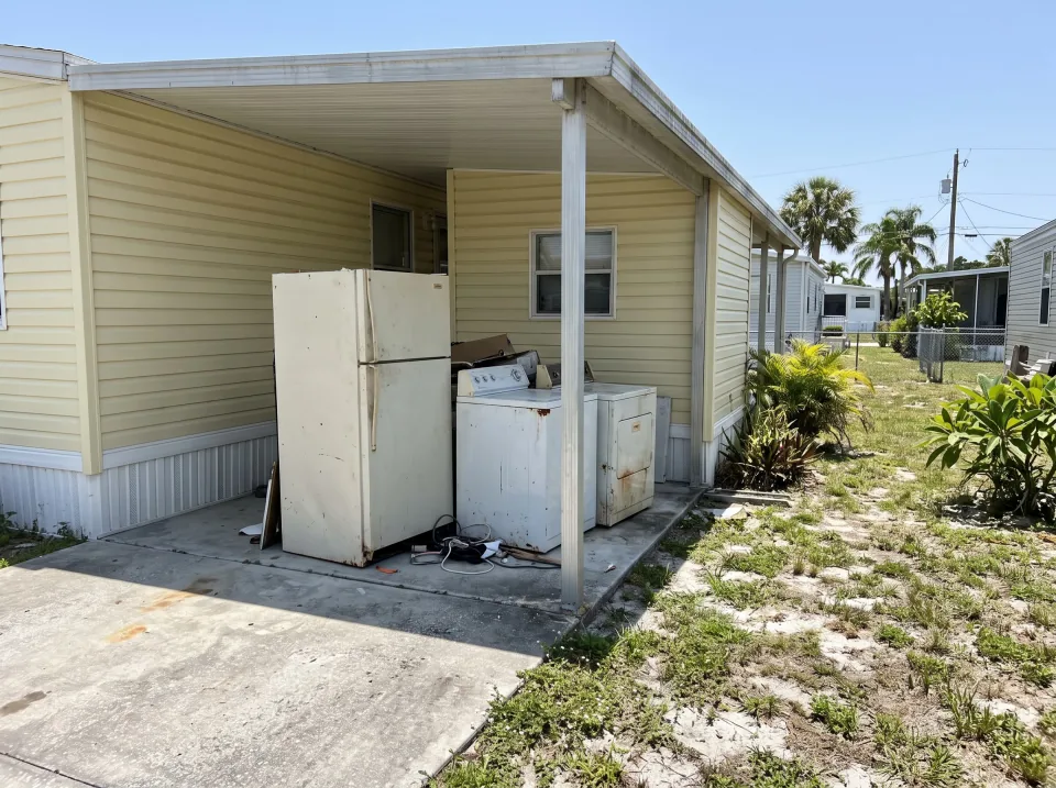 Illustration: an old refrigerator, washer and dryer wheeled out of a home's utility area onto a dolly